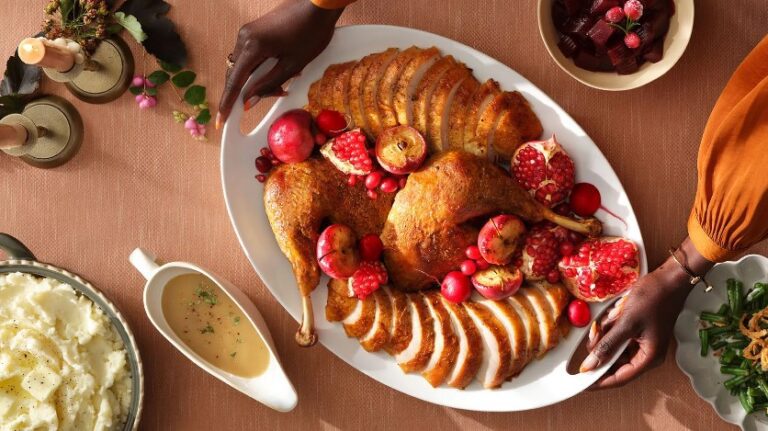 Thanksgiving meal essentials on dinnerware on a table